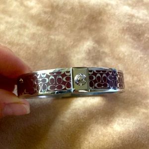 Coach bracelet brown and silver in color.